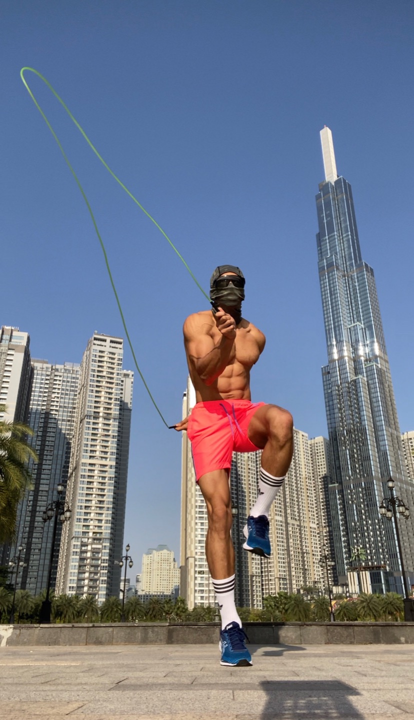 OYOTTA skipping rope outdoors in front of a modern city tower